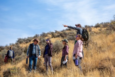 A group of hikers look off into the distance