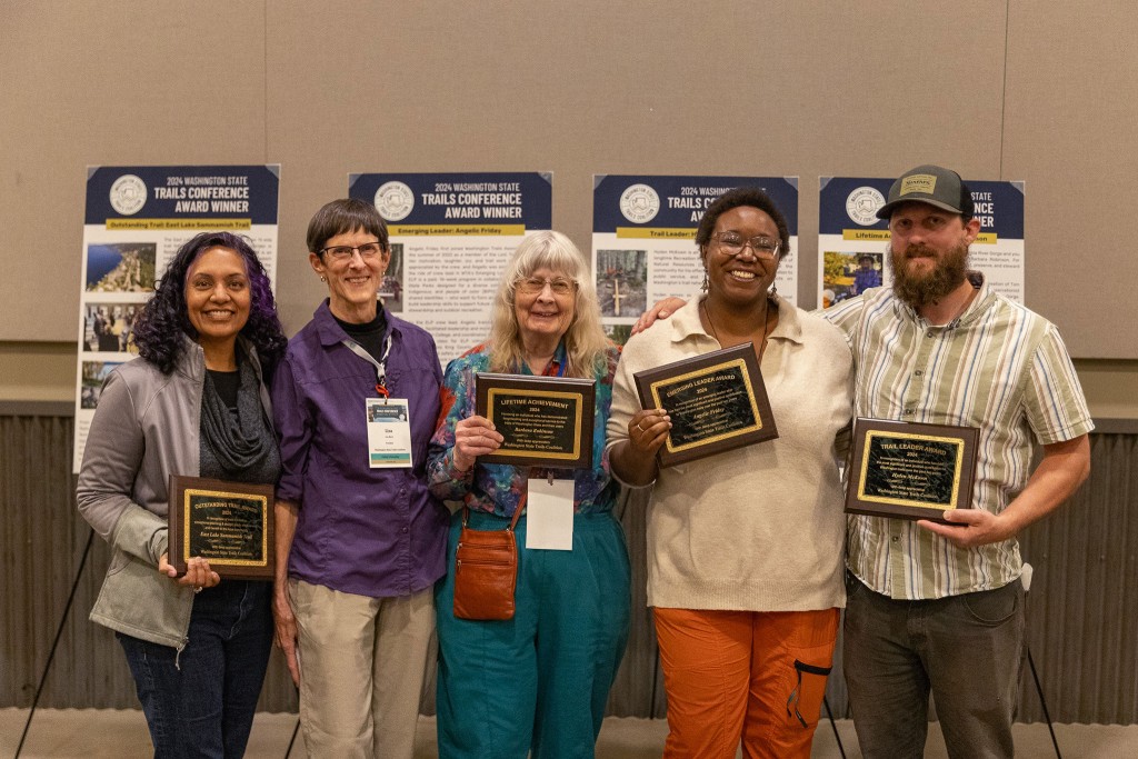 WSTC Board President, Lisa Black, stands alongside the four recipients of trail awards in 2024.